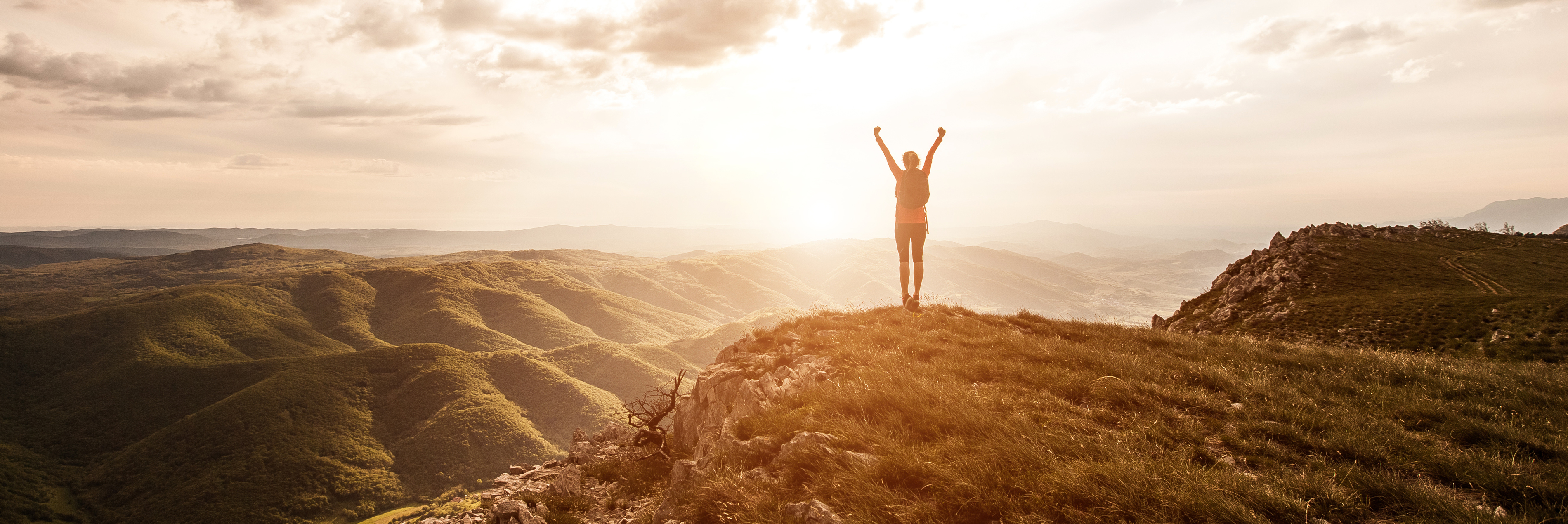 Woman on top of mountain