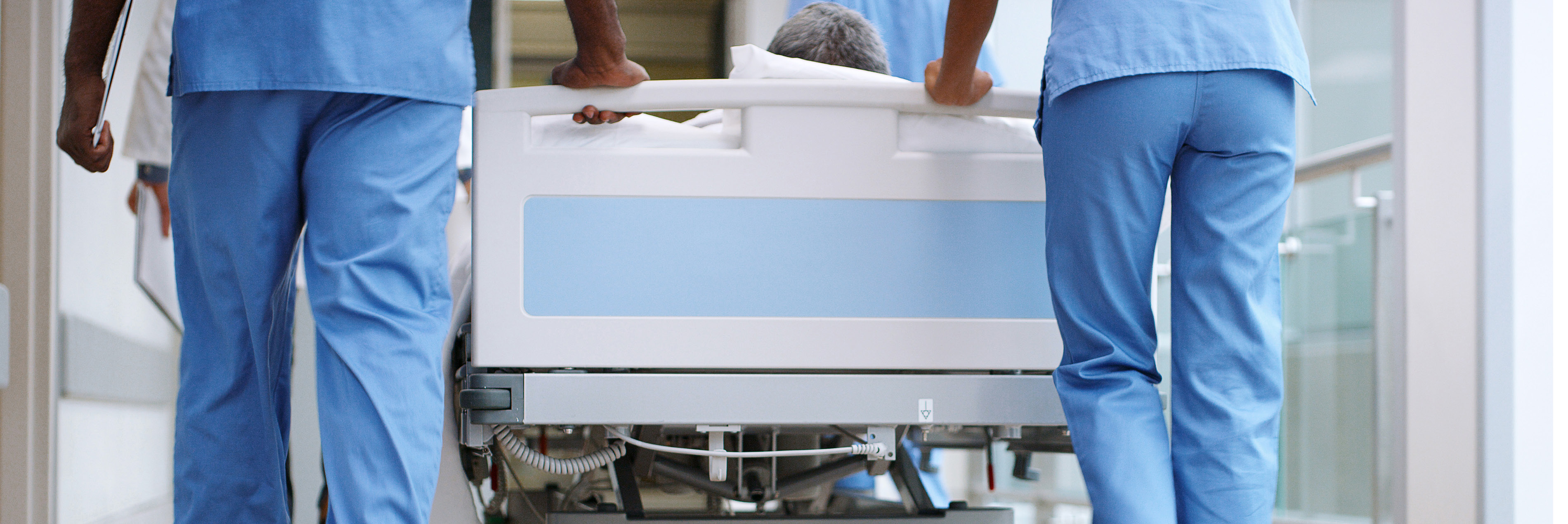 Nurses pushing bed