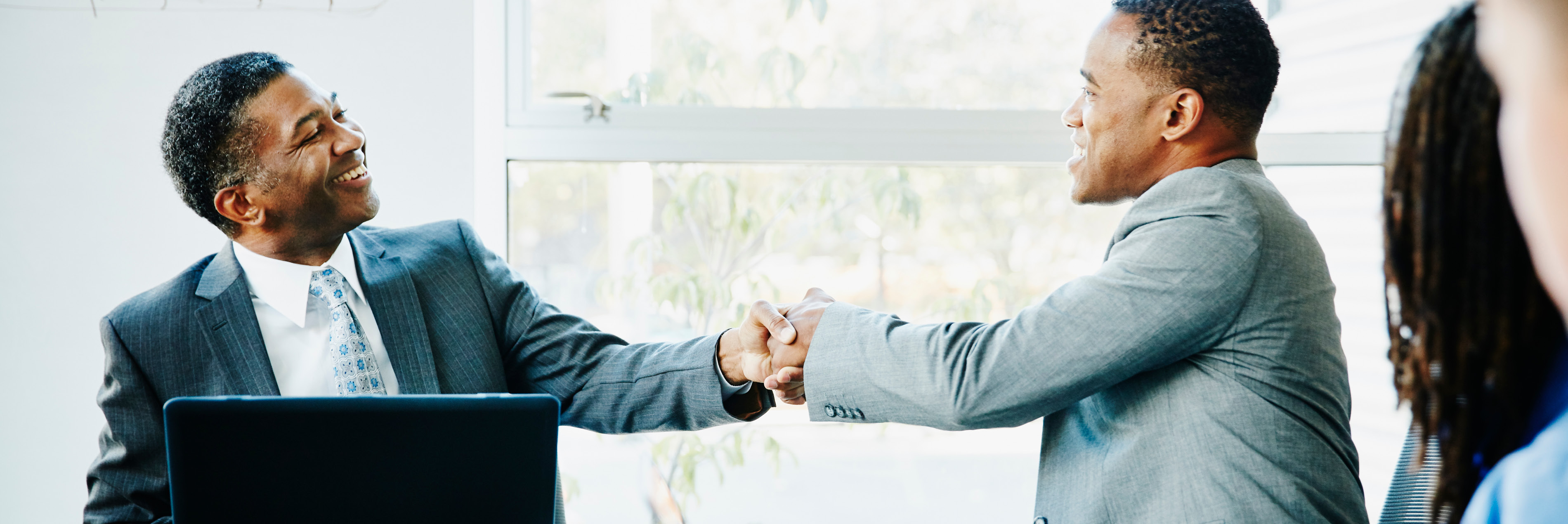 Businessmen shaking hands in meeting