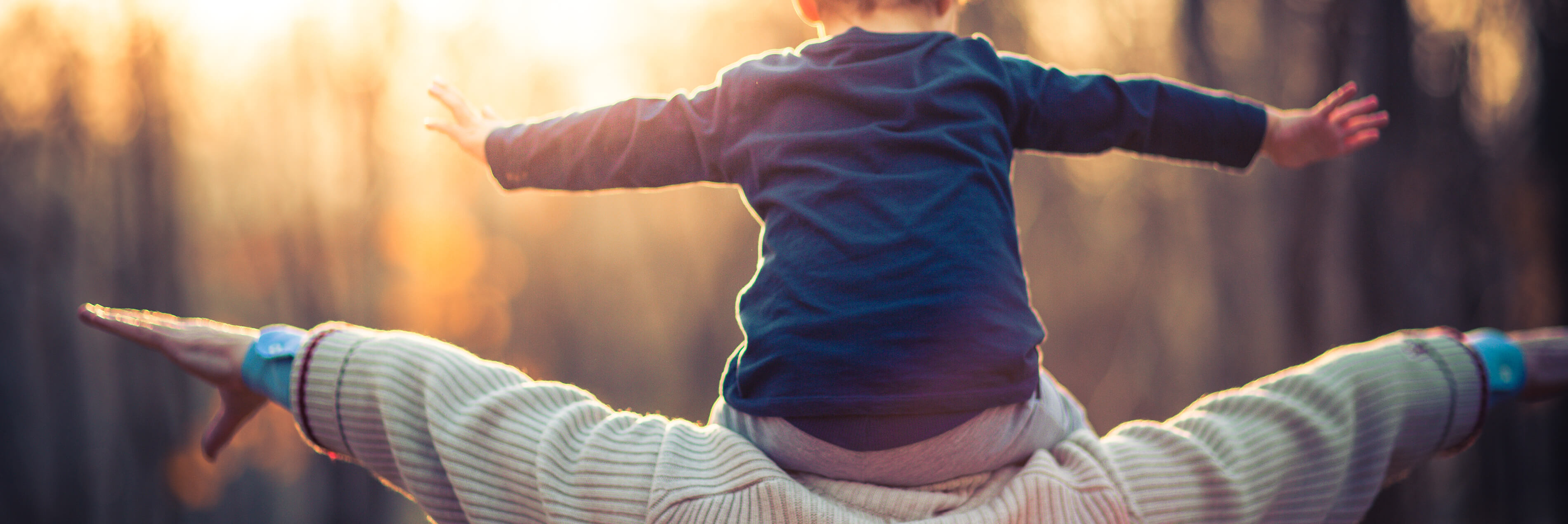 Boy and father with outstretched arms