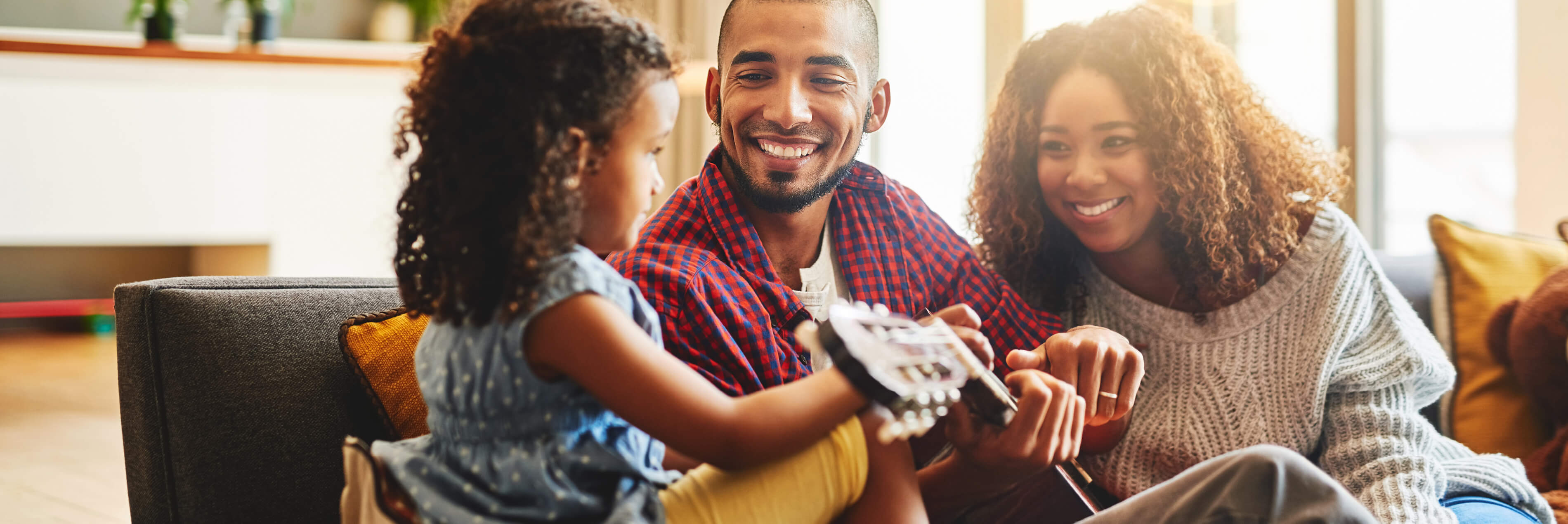 Family smiling playing guitar