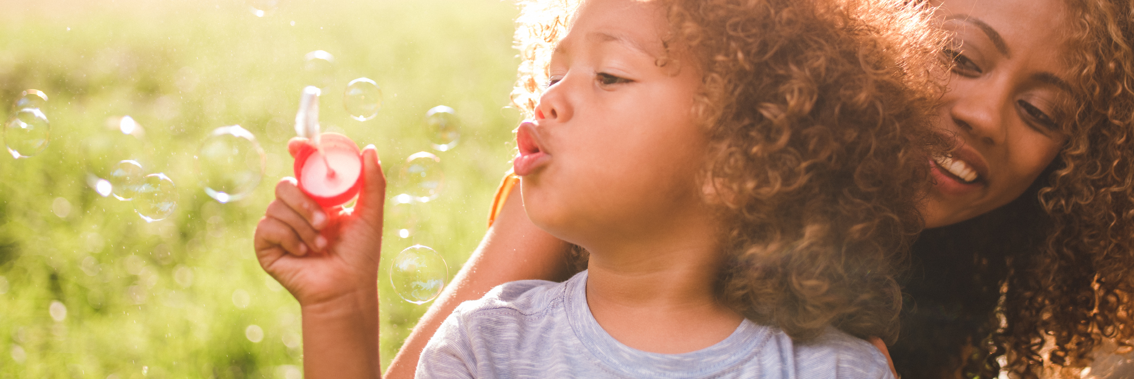 Mother and child blowing bubbles