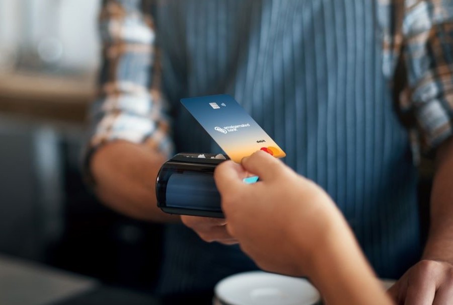 person using climate impact card to tap and pay