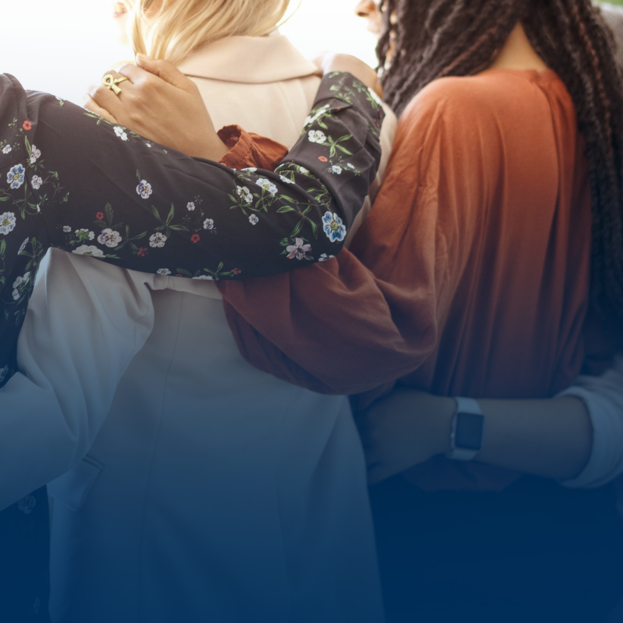 Women putting arms around each other