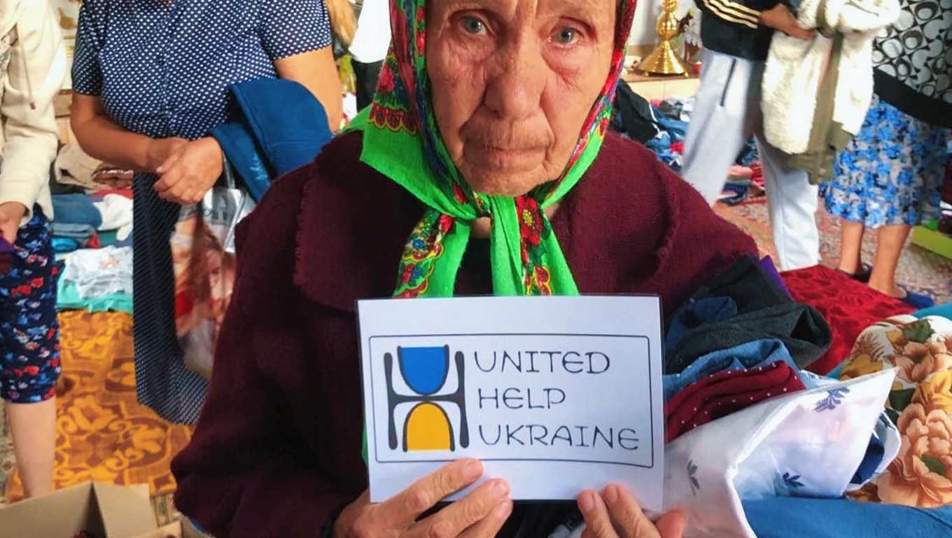 Woman holding United Help Ukraine sign