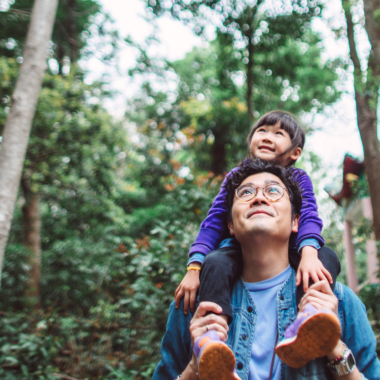 Man holding child on his shoulders