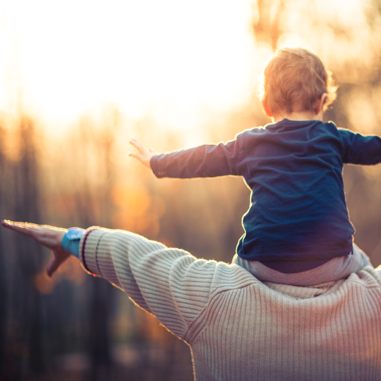 Man holding child on his shoulders