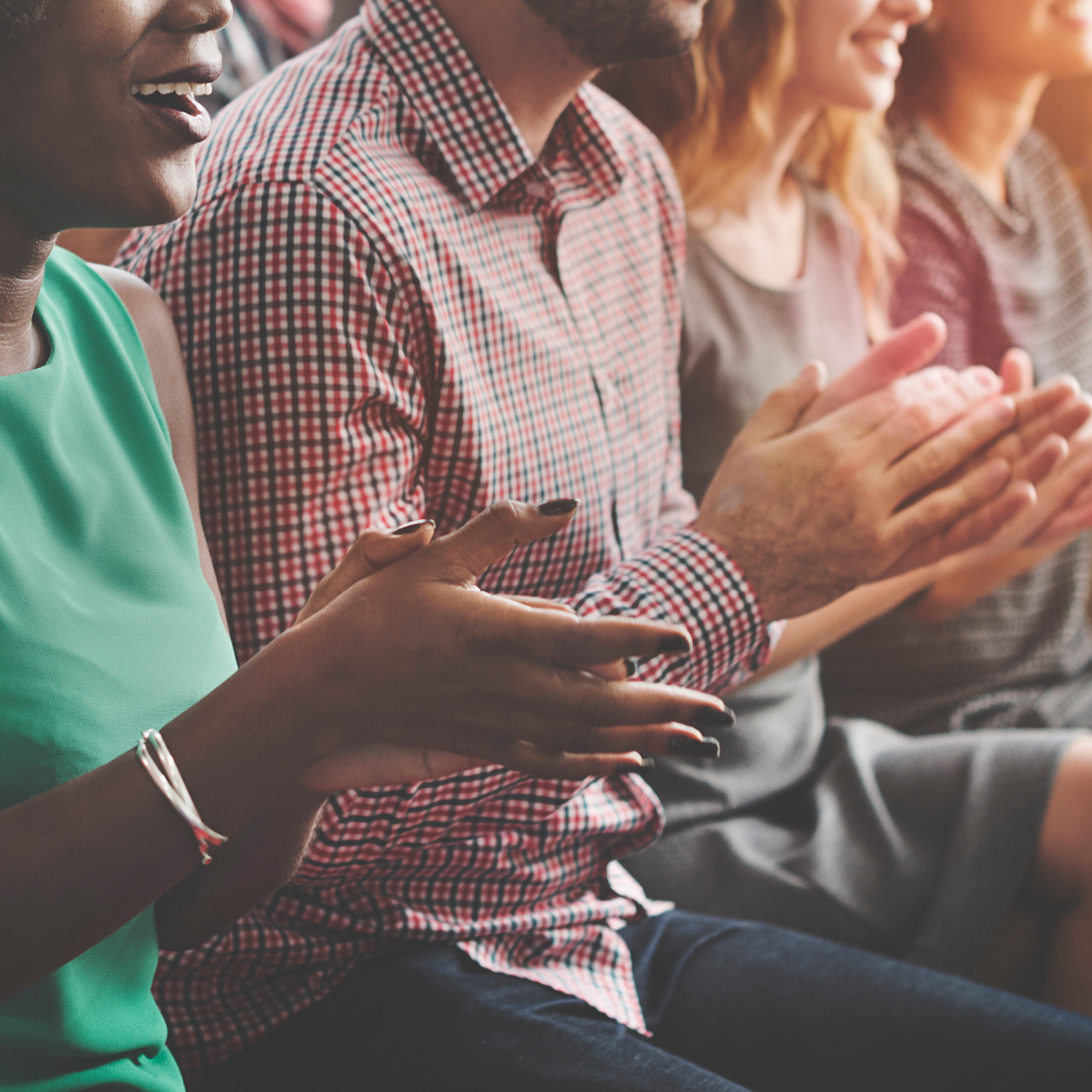 People clapping hands in meeting