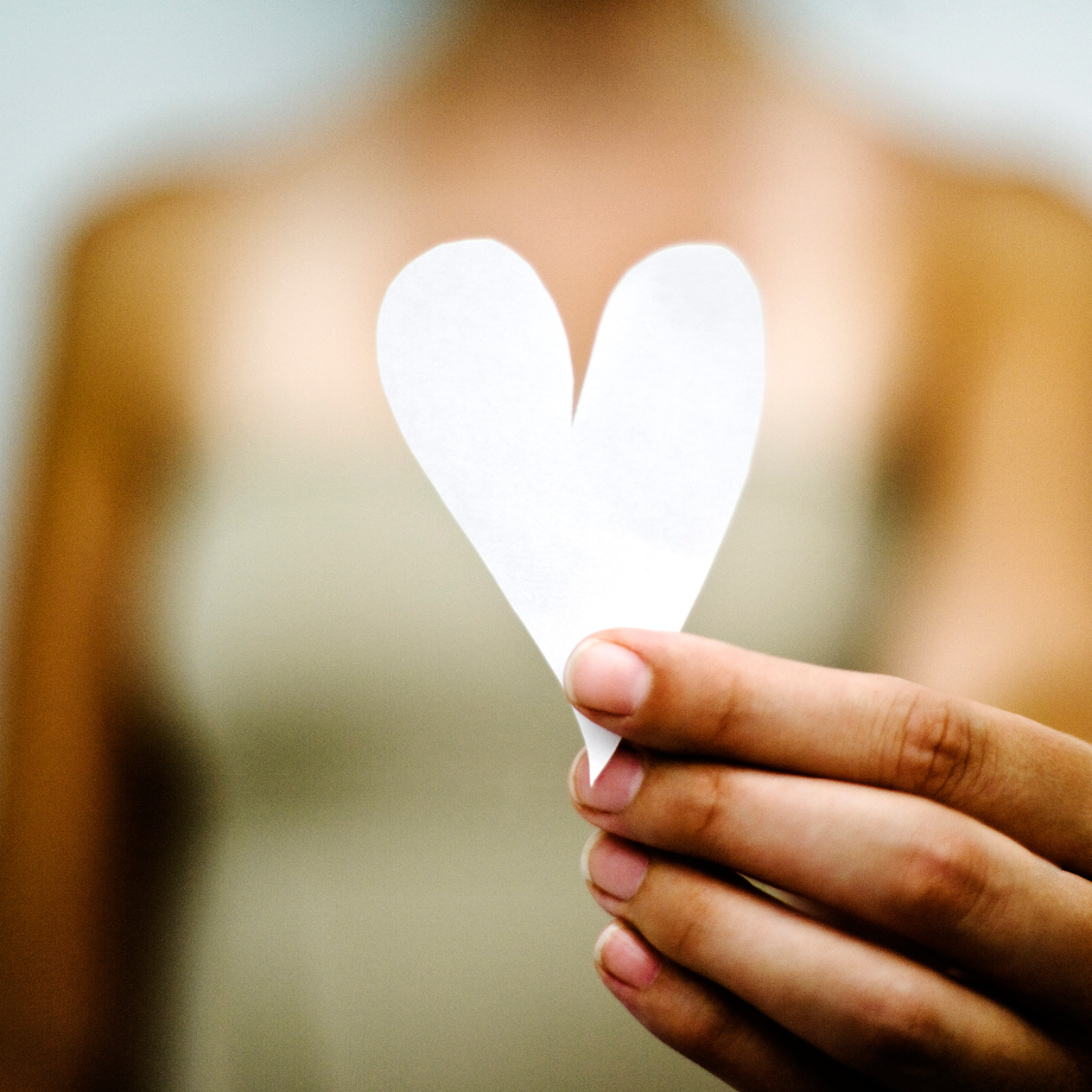 Hand holding paper heart