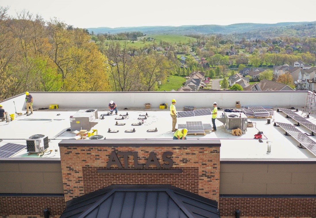 Solar Holler employees working on roof